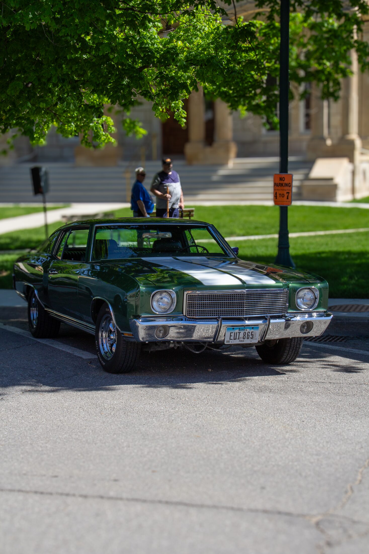Green classic car displayed outdoors