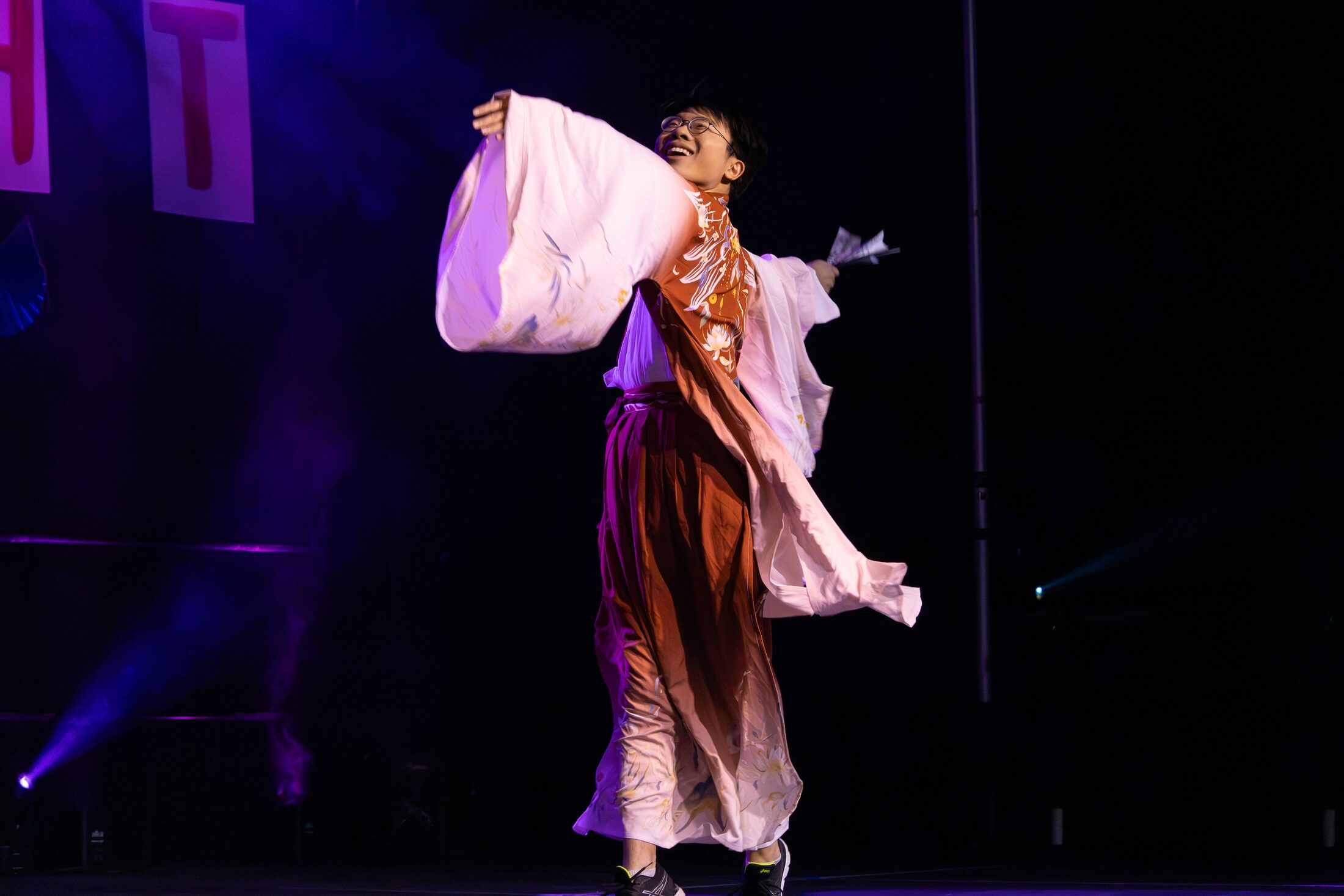 Traditional dance performance under stage lighting