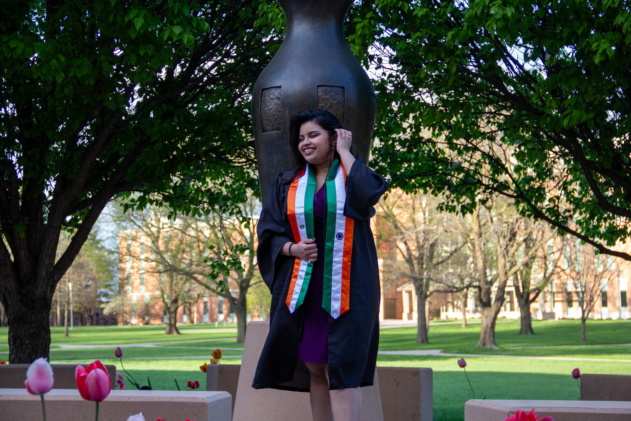 Graduate walking through campus