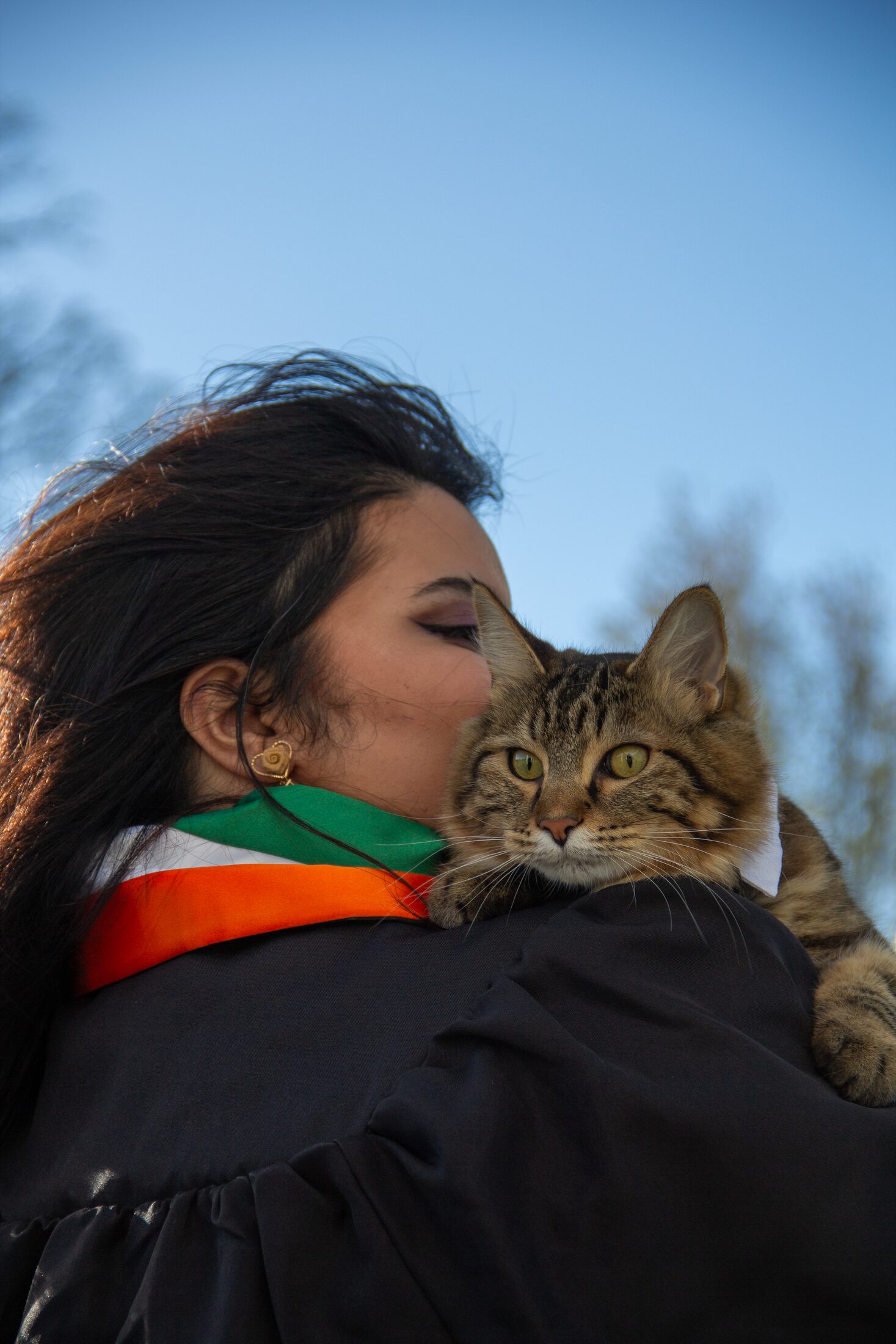 Graduate sharing a quiet moment with a cat