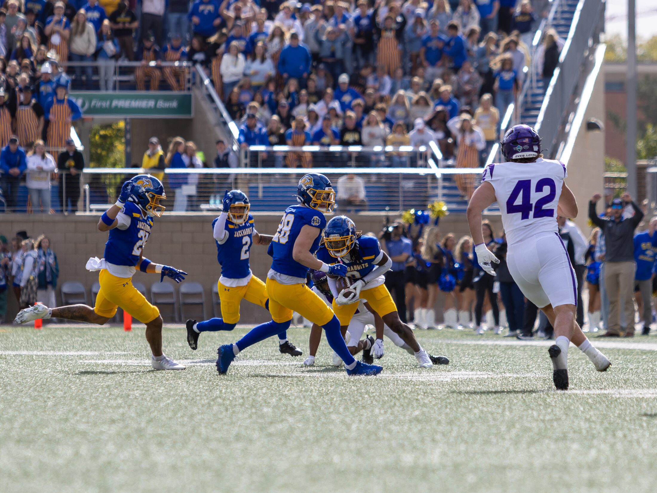 Football runner breaking through the defense